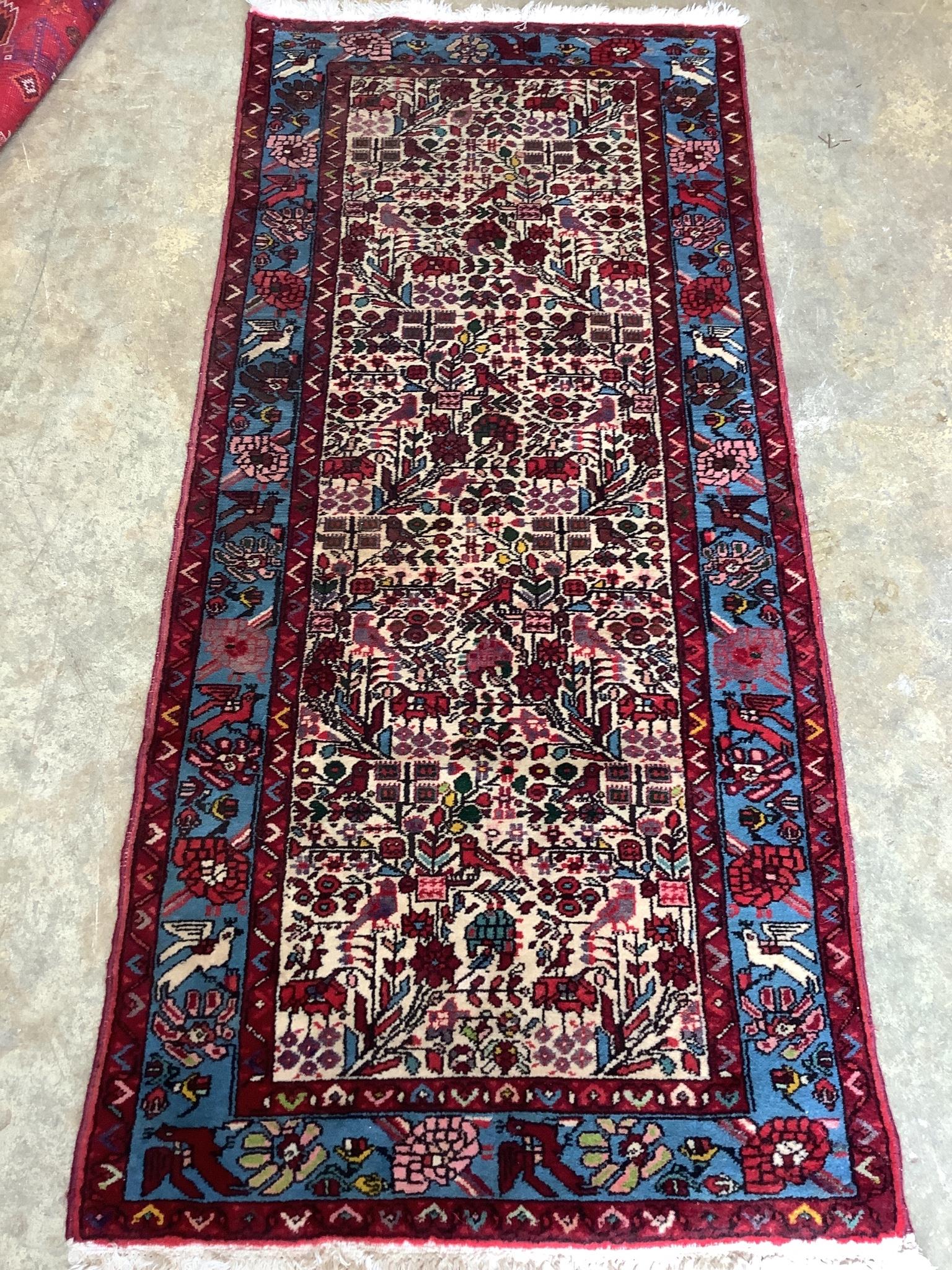 A North West Persian ivory ground rug, 192 x 88cm